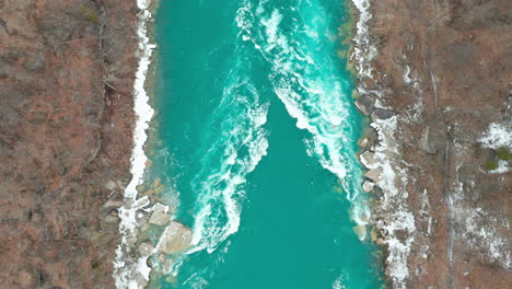 Aerial-shot-of-barren-trees-on-either-side-of-tel-green-river