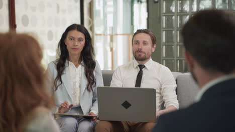 business meeting between two women and two men at an office 7