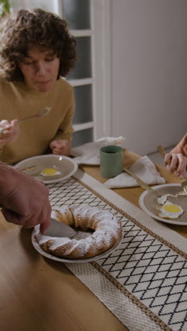 family dinner with cake and fried eggs