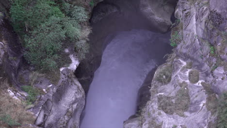a waterfall running through a deep gorge.