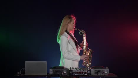 woman playing saxophone on a dj setup