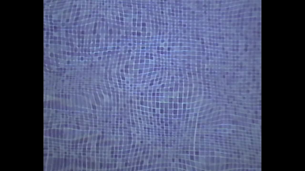 Wavy reflections on mosaic pool bottom in retro footage