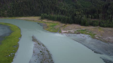 aerial drone of wide soo river and lone red car in wilderness canada 4k