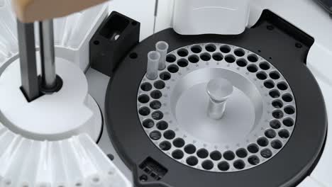 process of needle probe pouring the reagent into tubes for the test procedure