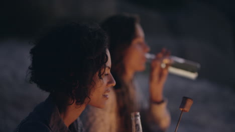 Beach-Party-at-sunset-with-bonfire-and-roasting-marshmellows-with-friends