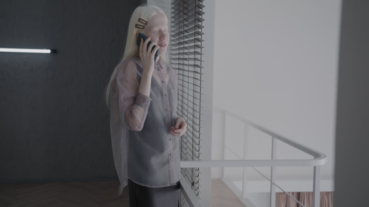 Young Woman Talking on Phone at Home