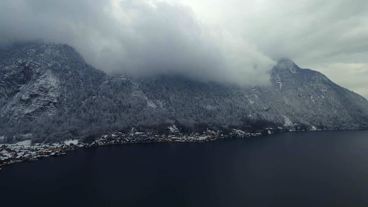 Footage filmed with a drone over a lake by a town called Hallstatt in Austria in Europe
