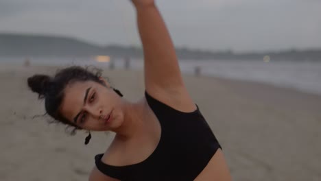 A-close-up-shot-captures-an-Indian-woman-focused-on-her-fitness-routine-at-the-beach