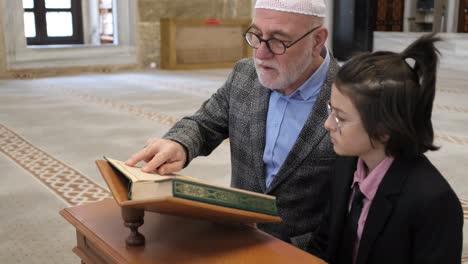 man teaching quran