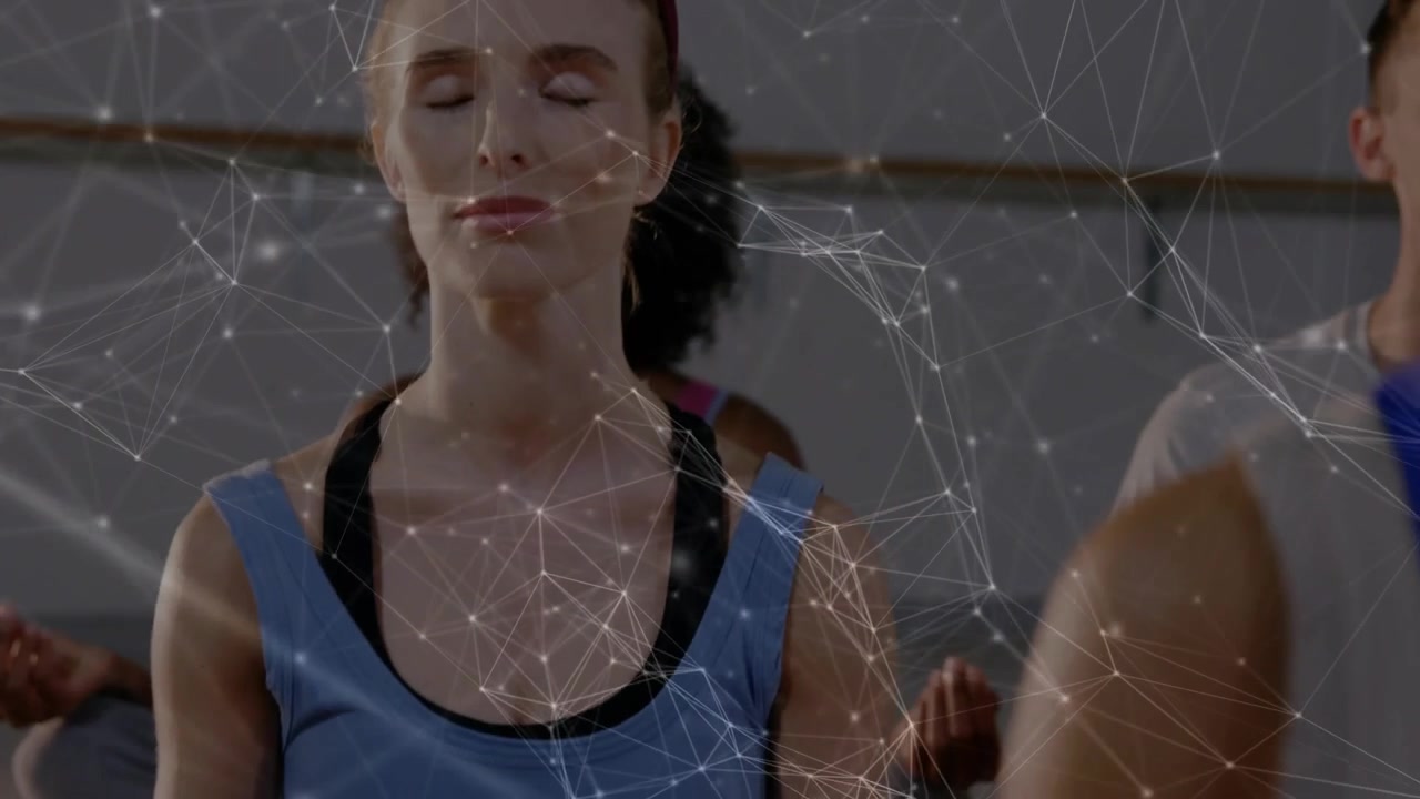 Camera pulling back, woman in blue tank holding mudra, candles, network overlay aiding meditation