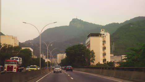 Driving through the roads of Rio De Janeiro overlooking mountains under the hazy and grey sky, Brazil