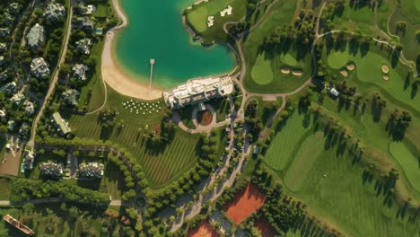 Aerial-overhead-view-of-a-golf-resort-with-beautiful-abstract-patterns,-sand-traps,-trees-tennis-courts,-and-a-turquoise-lake