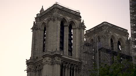 Notre-Damme-Cathedral-in-Paris-France-being-repaired-from-fire-with-scaffolding,-Pan-right-shot