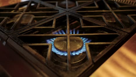 Stovetop-flame-turning-on-in-a-restaurant-kitchen