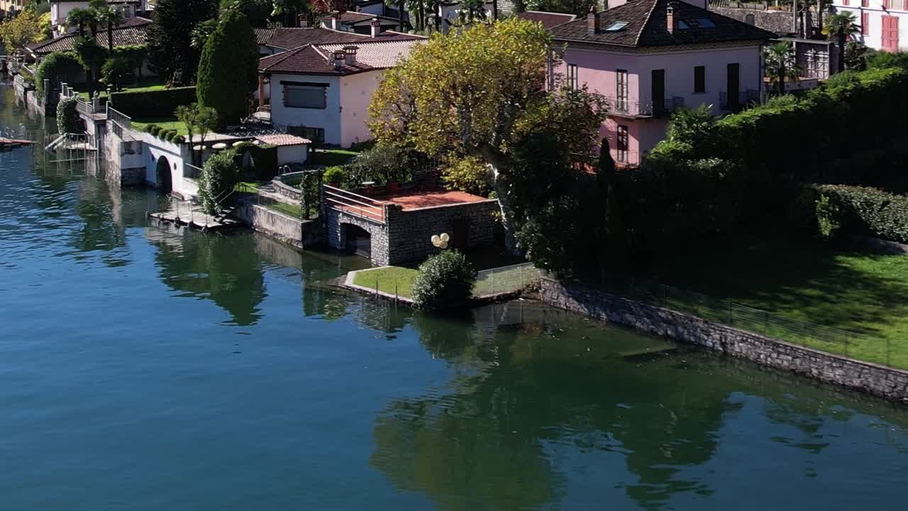 Beautiful aerial view of lakeside homes in the Italian Alps during fall
