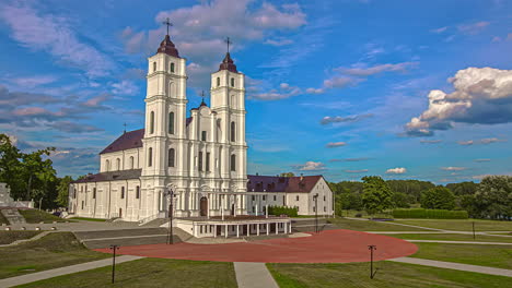 Slow-motion-view-of-the-Basilica-of-the-Assumption,-Aglona-Roman-Catholic-church,-Aglona-cathedral-and-Christian-Kings-mountain-with-garden-drone-flight