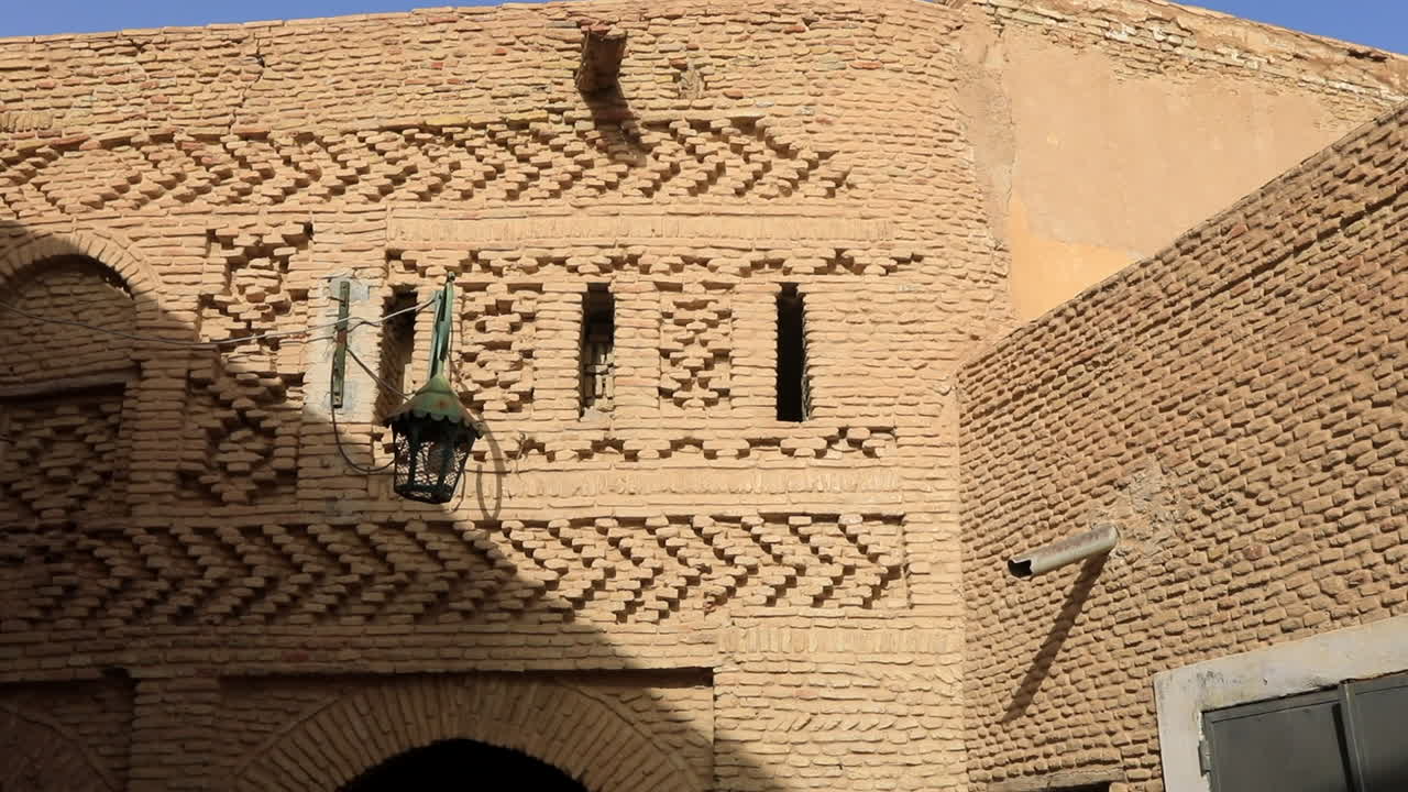Sunlit ancient Arabic street in Sbeitla with intricate brickwork
