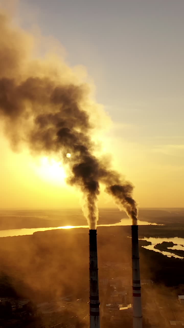 Smoke from industrial pipes. The top of the factory pipe soars Vertical video