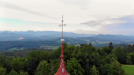 Holy-cross-faith-structure-guarding-Domzale-town-Slovenia-aerial