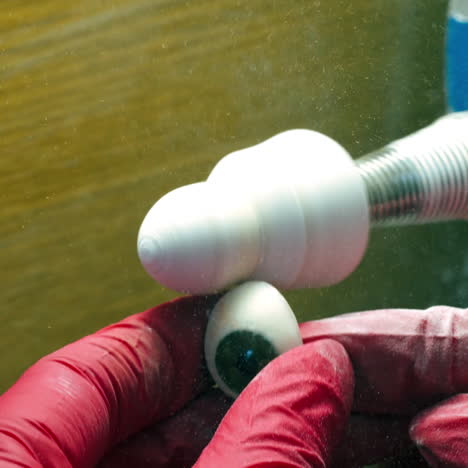 polishing eye prosthesis. instrument for cleaning plastic eye in the laboratory. manufacturing of the eye prosthesis.