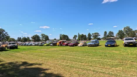 classic cars displayed outdoors under blue skies