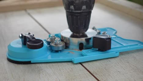 a worker uses a unique special tool to drill a hole in ceramic tiles, making a clean cut at the end