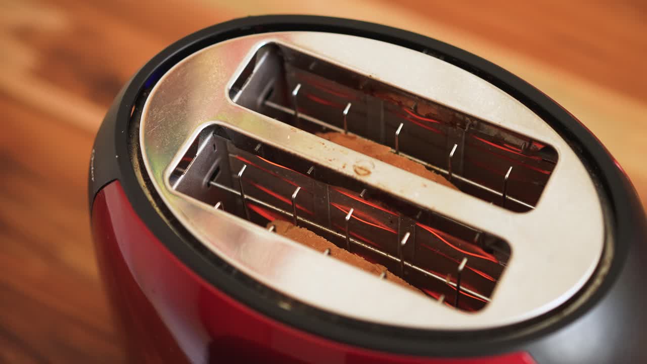 Sliced white bread heating on toaster on kitchen table breakfast