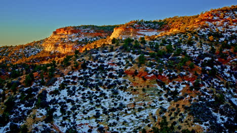 drone shot flying over amazing red rock canyon with great dawn light