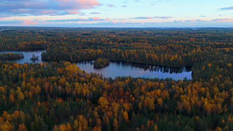 dusk at a lake in the middle of an endless wilderness forest in southern finland