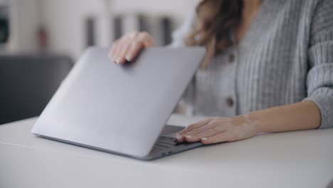 woman with skin pigmentation disorder closing laptop, freelancer finishing work