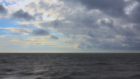 Dark-sea-and-blowing-clouds-on-stormy-day,-long-exposure-time-lapse-30x