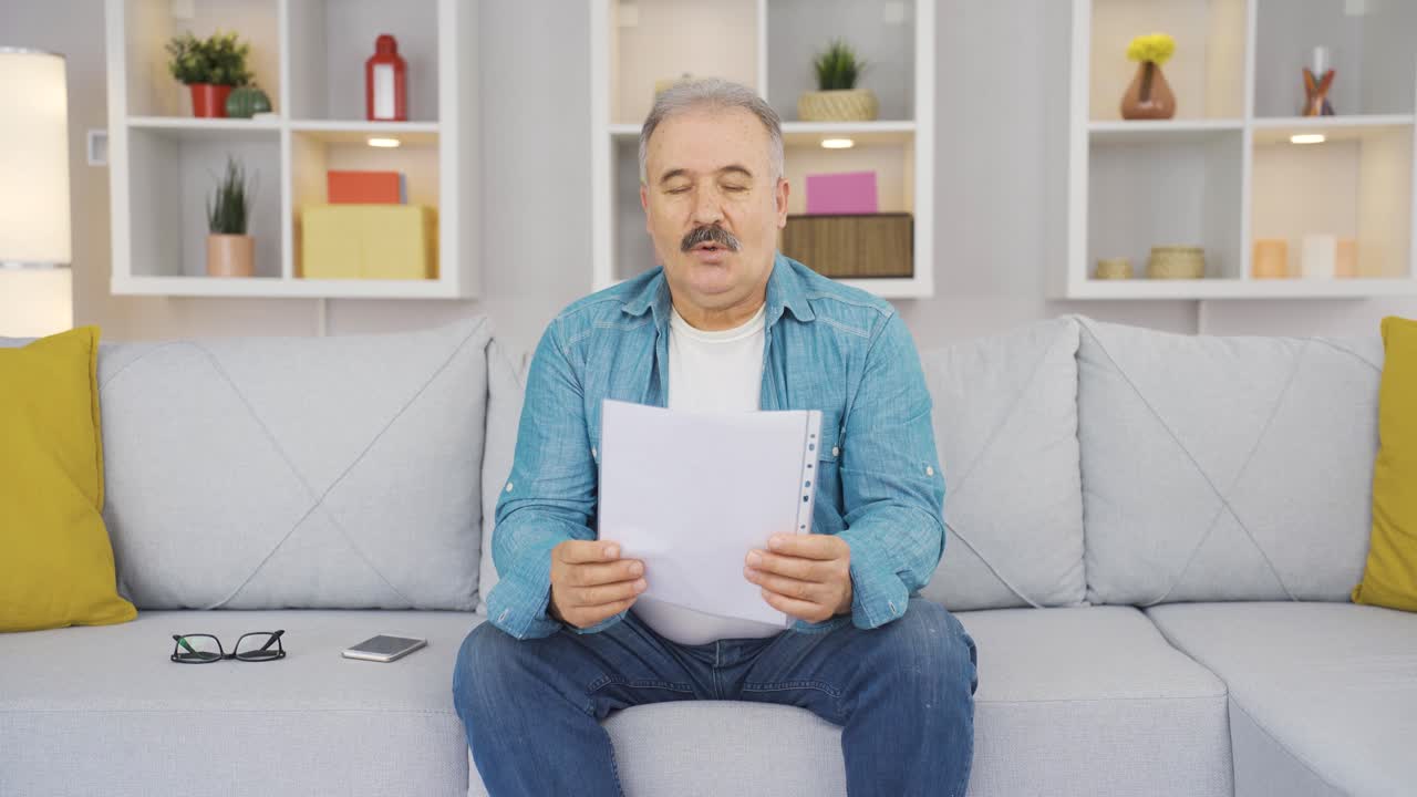 The old man looking at the papers rejoices.
