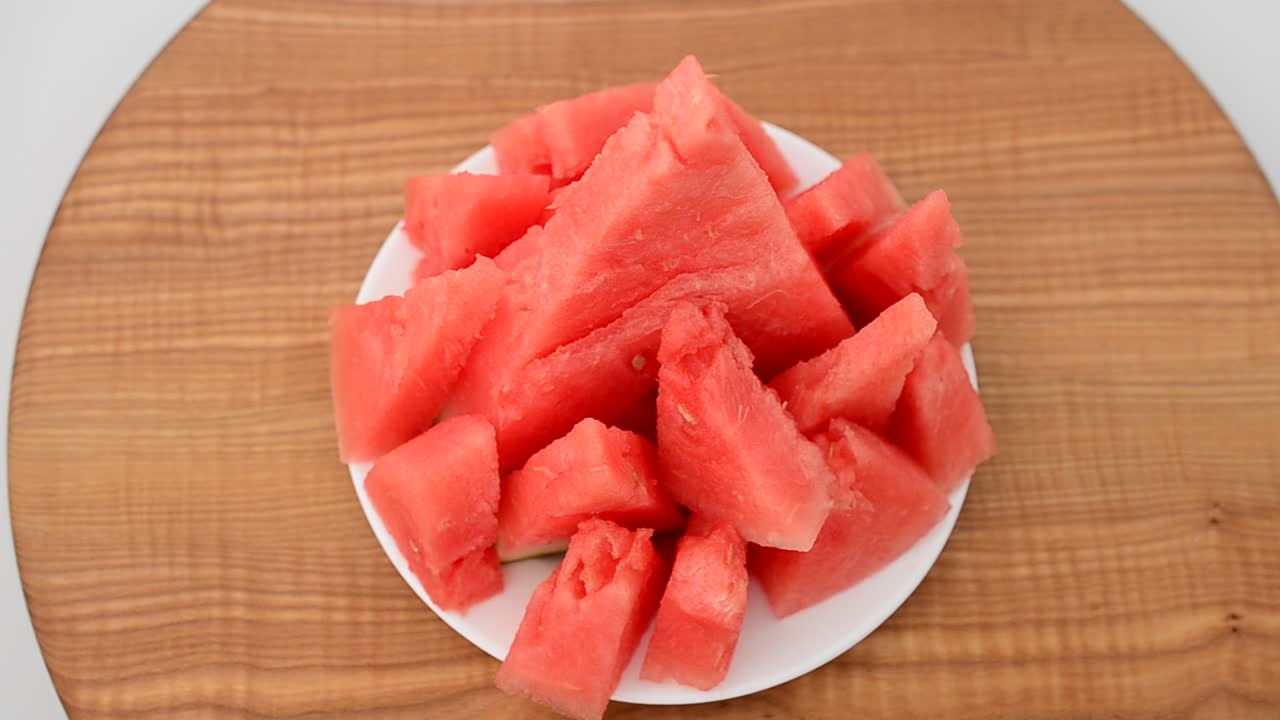 Shooting of a watermelon on a kitchen board. Shooting in the movement