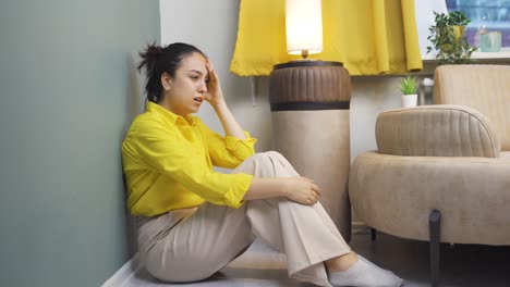 The-young-woman-sitting-by-the-wall-is-angry-with-herself.