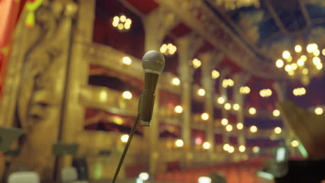 live performance at a historic theater with a microphone focused in view