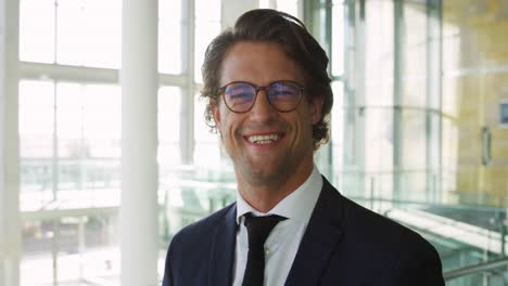 Portrait-of-young-businessman-in-modern-office-building