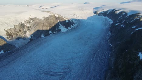 drone footage of longest glacier arm in europe - tunsbergdalsbreen glacier jotedalsbreen national park, norway at sunrise