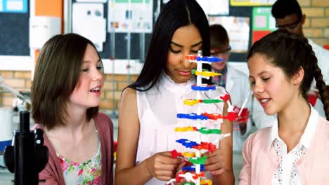 School-students-experimenting-molecule-model-in-laboratory