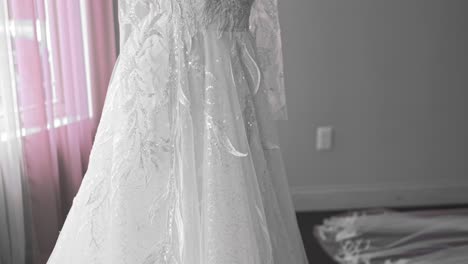 an upclose shot of a white wedding dress on a manican