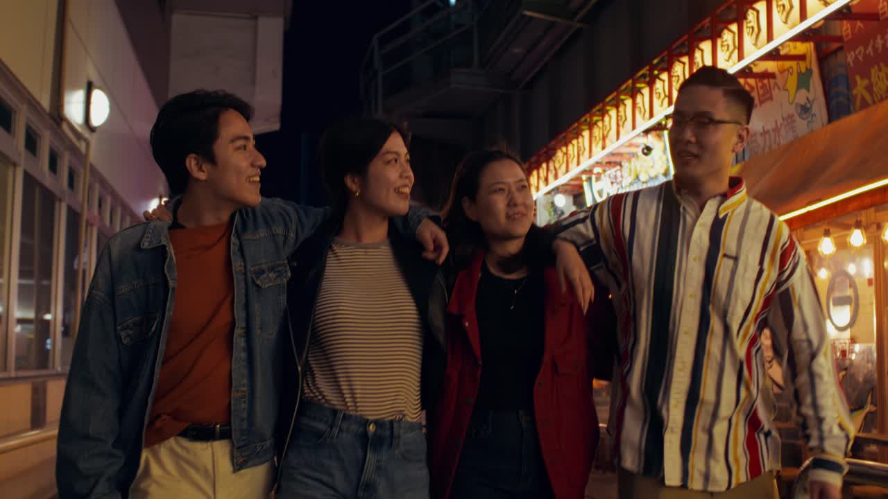 Friends enjoying a night out in a city street