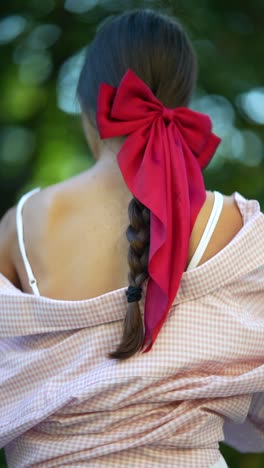 woman with red bow in her hair