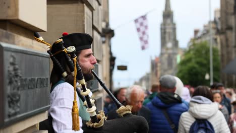 bagpiper playing amidst a bustling crowd