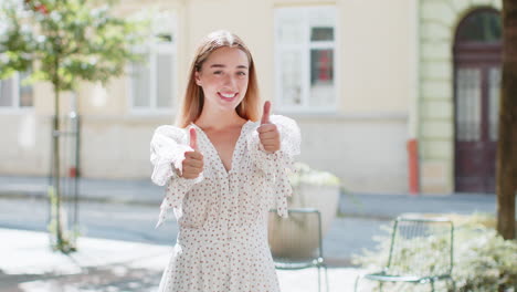 woman showing thumbs up like sign positive something good positive feedback in urban city street