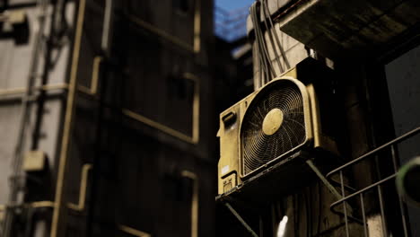 old yellow air conditioner on a city building