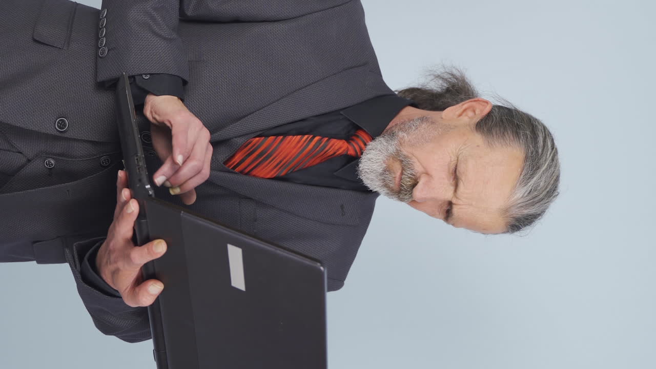Vídeo vertical de empresário idoso irritado. O empresário idoso questiona seu fracasso.