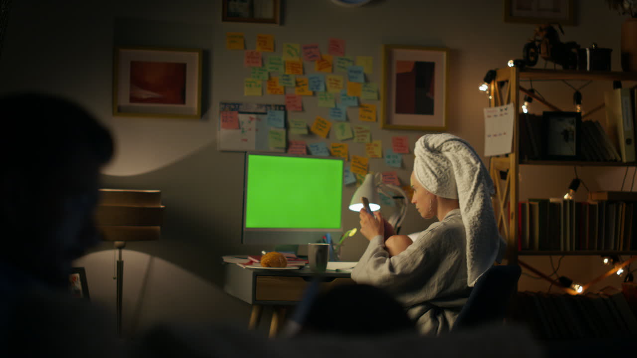 Young family working home office. Focused woman browsing smartphone at night