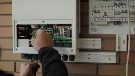 un electricista instalando un inversor en un hogar. la imagen muestra habilidad técnica, herramientas modernas y atención a la seguridad en el trabajo eléctrico