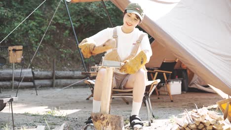 young woman chopping firewood