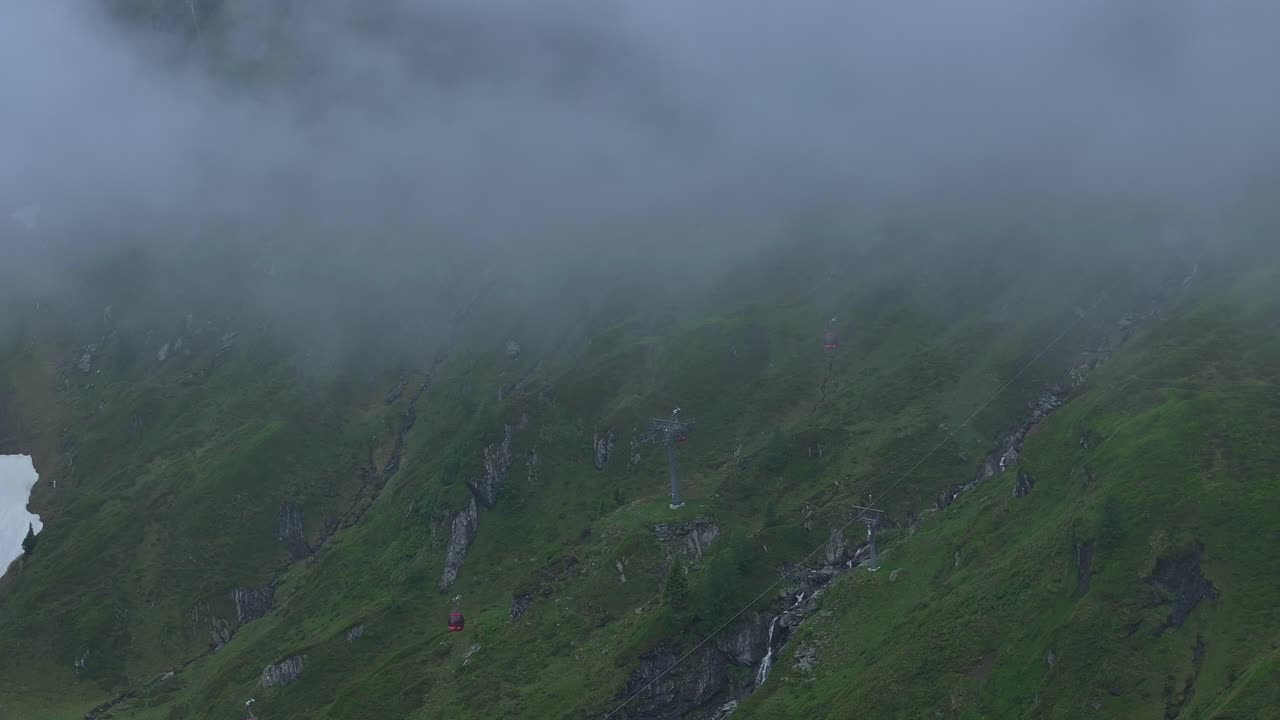 떨어지는 짙은 안개로 인해 스키어를 수송하는 케이블카의 운행이 위협받고 있습니다.