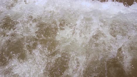 Fondo-De-Espuma-De-Agua-Del-Océano.-Cámara-Lenta-De-Olas-De-Espuma-Que-Llegan-A-La-Orilla-Del-Mar